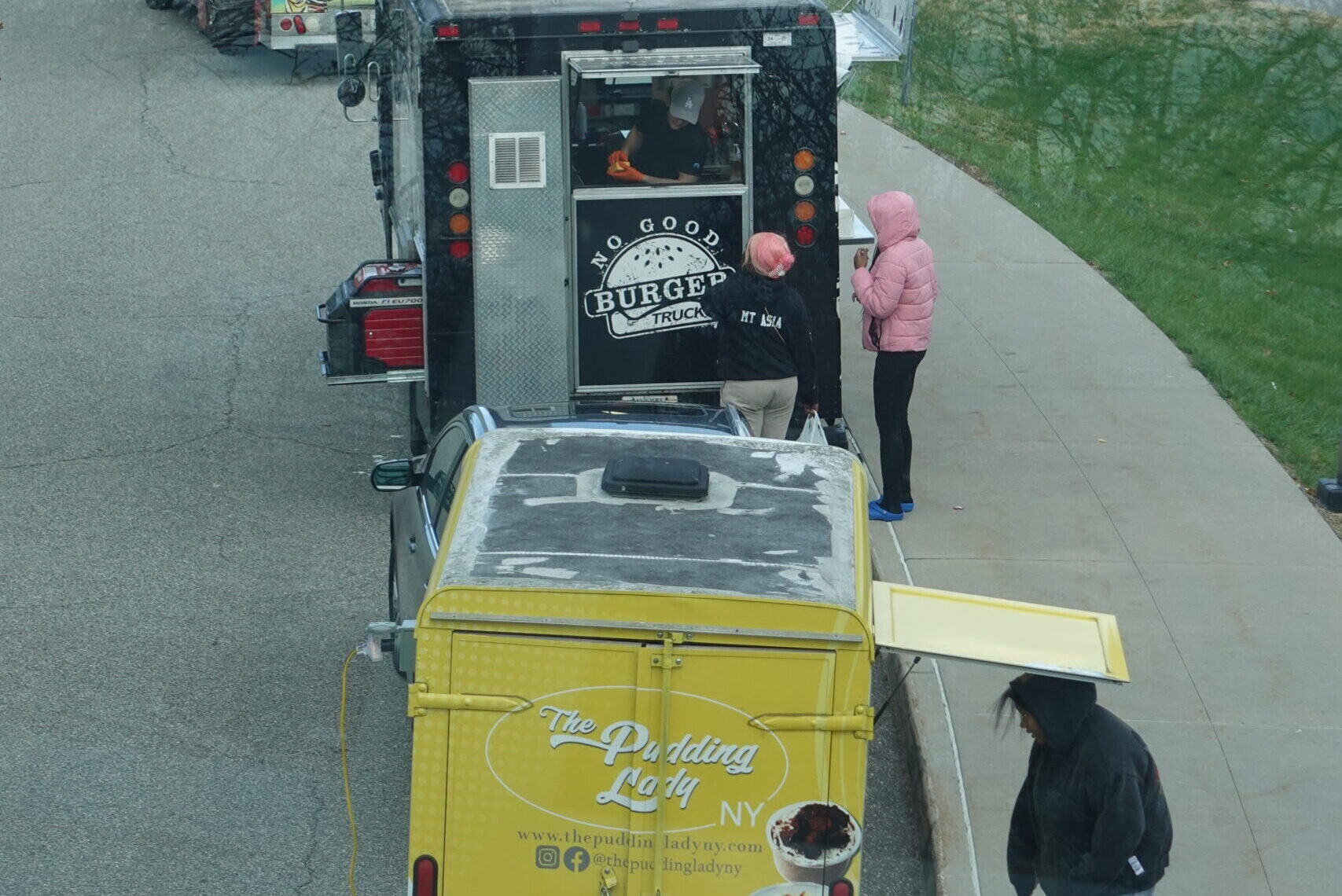 Food trucks lined up at an outdoor event, offering diverse gourmet mobile food services.