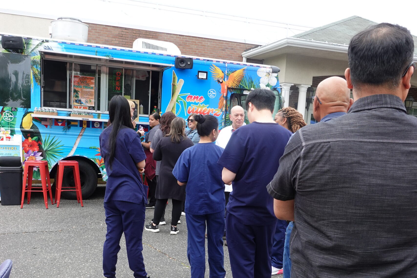 People lined up at a vibrant food truck, showcasing mobile food services and unique eats on wheels.